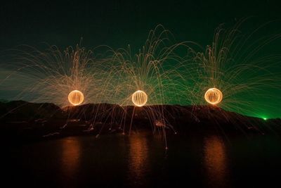 Firework display against sky at night