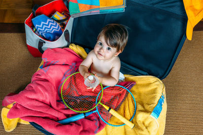 High angle view of boy sitting at toy