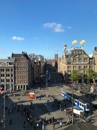 High angle view of people on city street against buildings