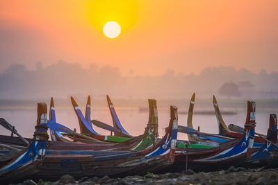 Colorful boats on the shore with surise near u bein bridge, myanmar 