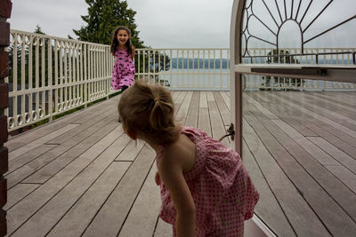 Sisters playing on floorboard