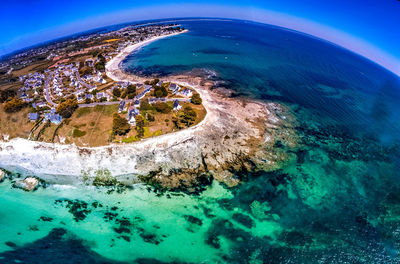 Aerial view of sea against blue sky