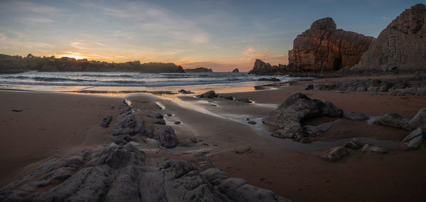 Panoramic view of beach against sky during sunset