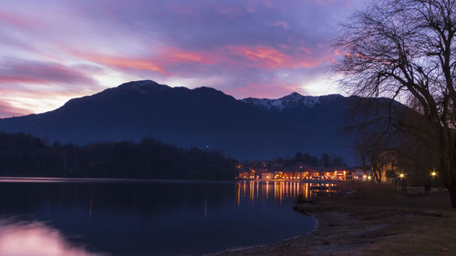 Scenic view of lake against sky at sunset