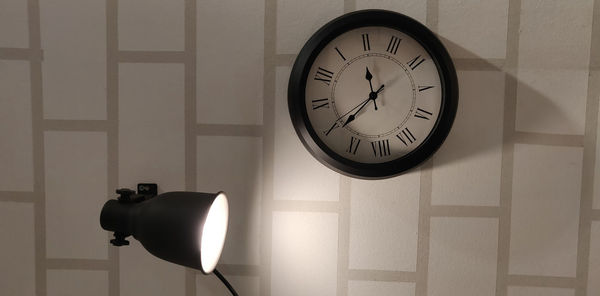 Close-up of clock on wall at home