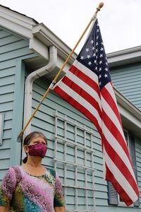 Low angle view of woman admiring united states flag