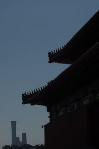 Low angle view of silhouette building against clear sky at dusk