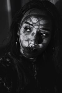 Close-up of young woman looking away in darkroom