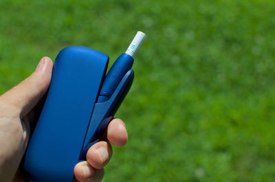 Close-up of person hand holding blue ring