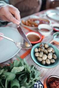 Midsection of person preparing food on table