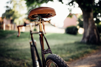 Close-up of bicycle wheel on field