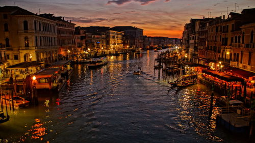 Canal passing through city at night