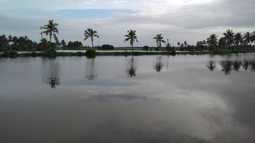 Scenic view of lake against cloudy sky