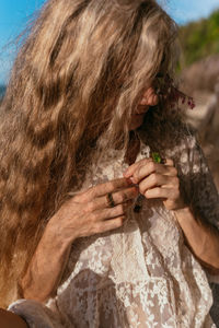 Rear view of woman with arms raised