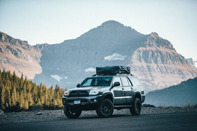 Car on mountain road against clear sky