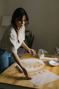 Young woman making christmas cookies