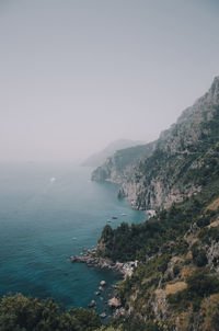 High angle view of sea and mountains against sky