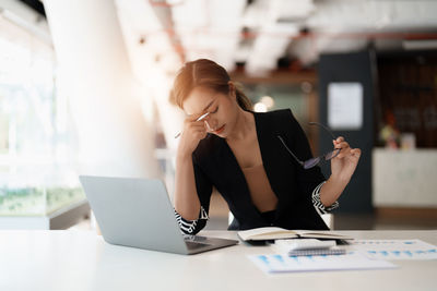 Young woman using laptop at office