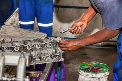 Midsection of man working at garage