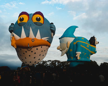 Sculpture of toys against sky