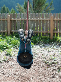 Boy playing on swing