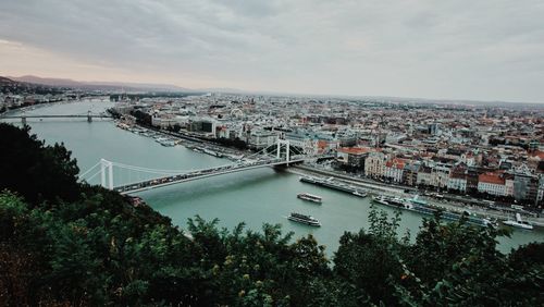 High angle view of bridge over river in city against sky