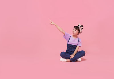 Woman sitting on pink flower