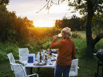 Woman drinking wine in garden