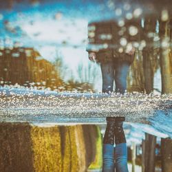 Close-up of fountain by window during rainy season