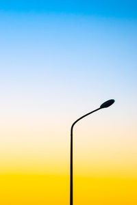 Silhouette street light against clear sky during sunset