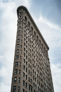 Low angle view of building against cloudy sky