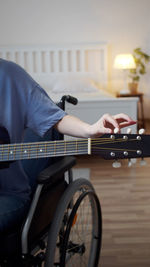 Rear view of man playing piano