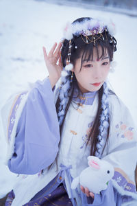 A girl in hanfu in the snow