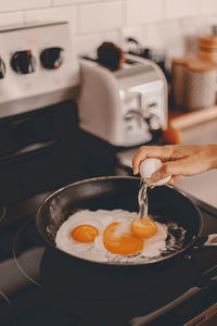 Midsection of person preparing food in kitchen