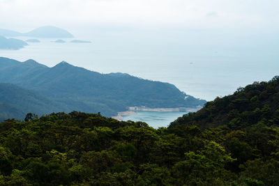 High angle view of sea and mountains against sky