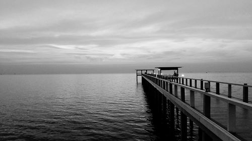 Pier over sea against sky