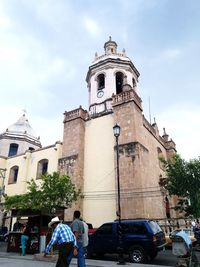 Low angle view of bell tower against sky