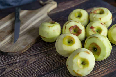Peeled apple for apple tart or pie on wood table background.