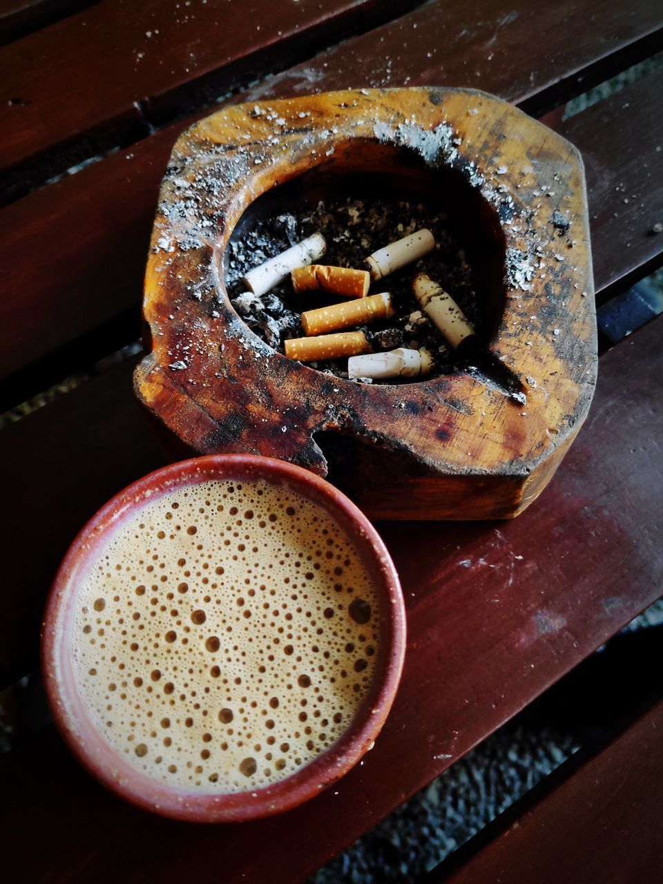 CLOSE-UP HIGH ANGLE VIEW OF CIGARETTE ON TABLE