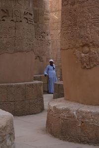 Full length of woman standing in front of temple