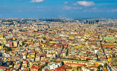 High angle view of cityscape against cloudy sky