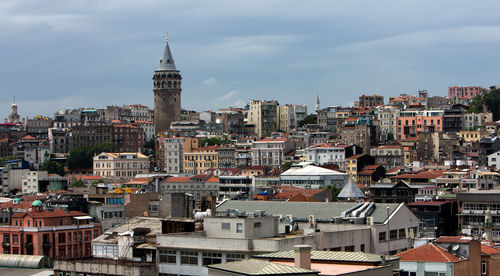 Galata tower amidst buildings in city against sky