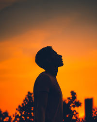 Silhouette man standing against sky during sunset