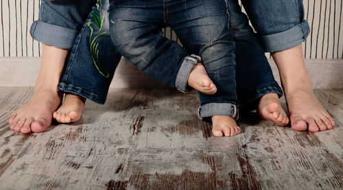 Low section of family standing on hardwood floor