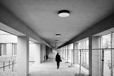 Rear view of woman walking in corridor