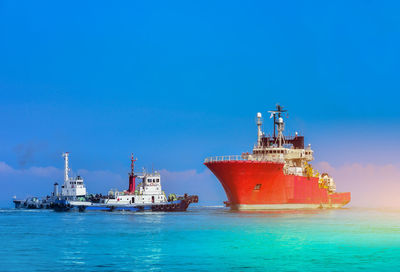 Ship in sea against blue sky