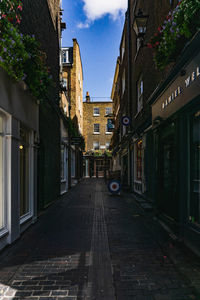 Street amidst buildings in city against sky