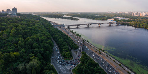 Aerial view of road bridge across river with heavy traffic jam in one direction.