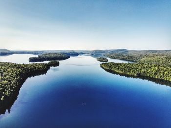 Scenic view of lake against clear blue sky