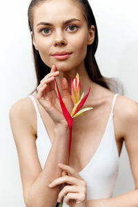 Portrait of young woman applying nail polish